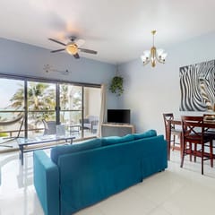 Beachfront condo with balcony, sea view, partial AC, pool, dock & kayaks