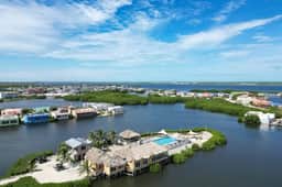 Vibrant, colorful lagoon-front suite with pool access, scenic patio, & WD - Image 2