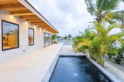 Stylish waterfront villa with pool, lush views & floor-to-ceiling windows - Image 2