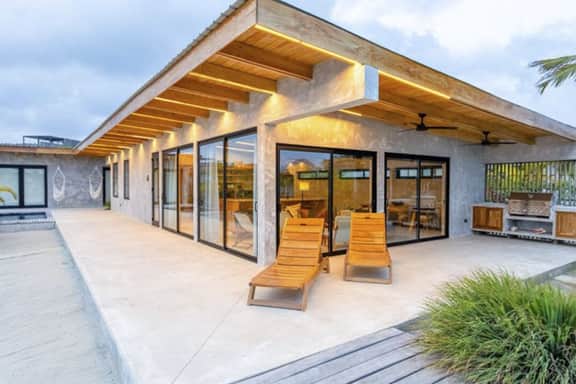 Stylish waterfront villa with pool, lush views & floor-to-ceiling windows - Image 3