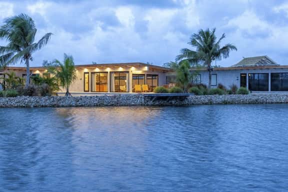 Stylish waterfront villa with pool, lush views & floor-to-ceiling windows - Image 4