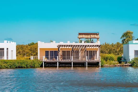 Cozy Waterfront Villa Home w Shared Pool, Water Views, WiFi, & AC - Walk to the Beach - Image 1