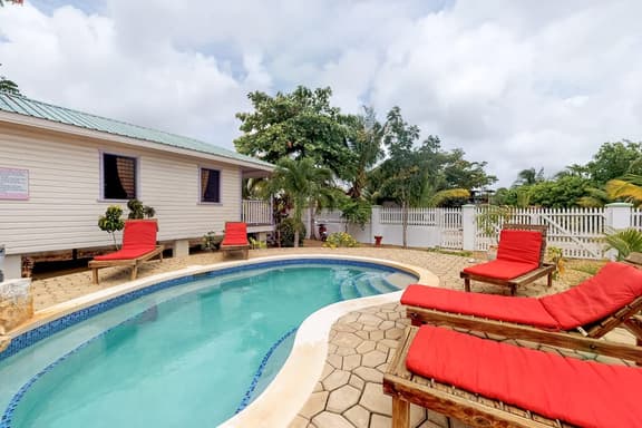 Cabana with a porch, hammock, & view of the pool & grilling area - Image 1