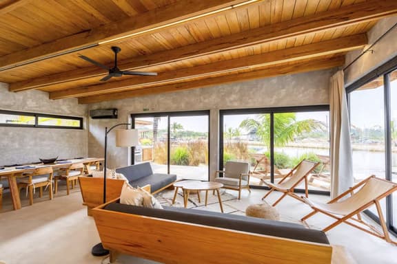 Stylish waterfront villa with pool, lush views & floor-to-ceiling windows - Image 1